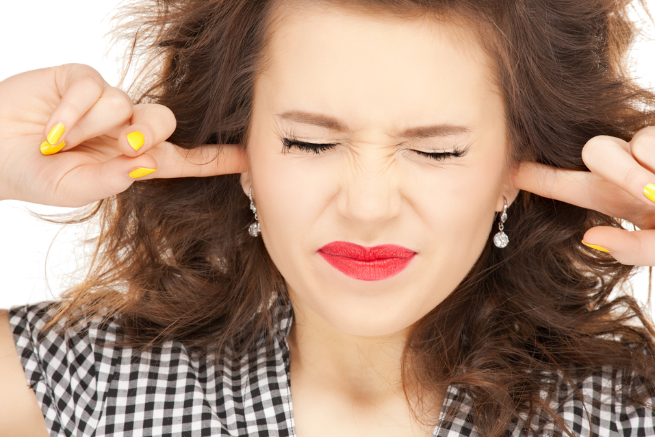 woman with fingers in ears