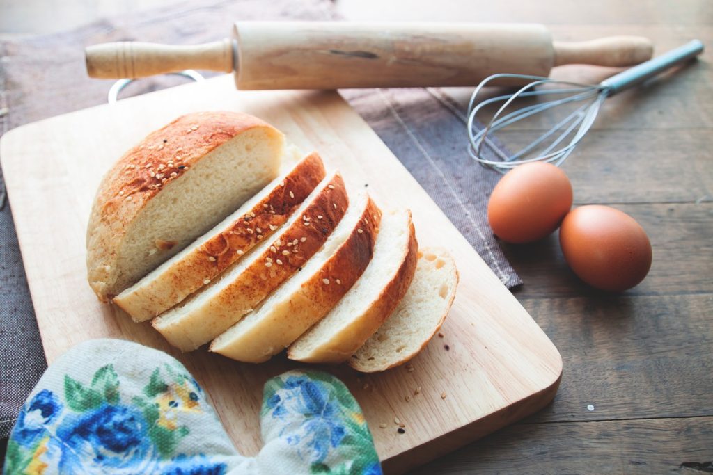 Sliced homemade bread with sesame on wood table