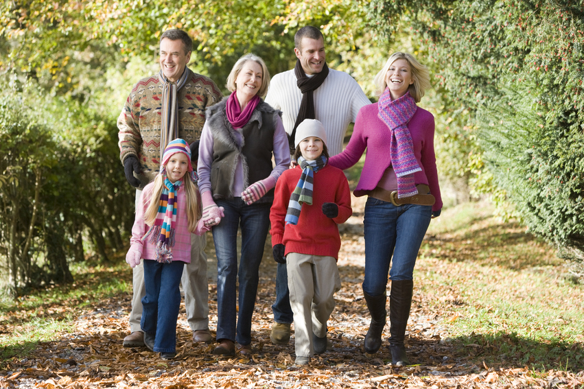 Multi-generation family on walk through autumn woods