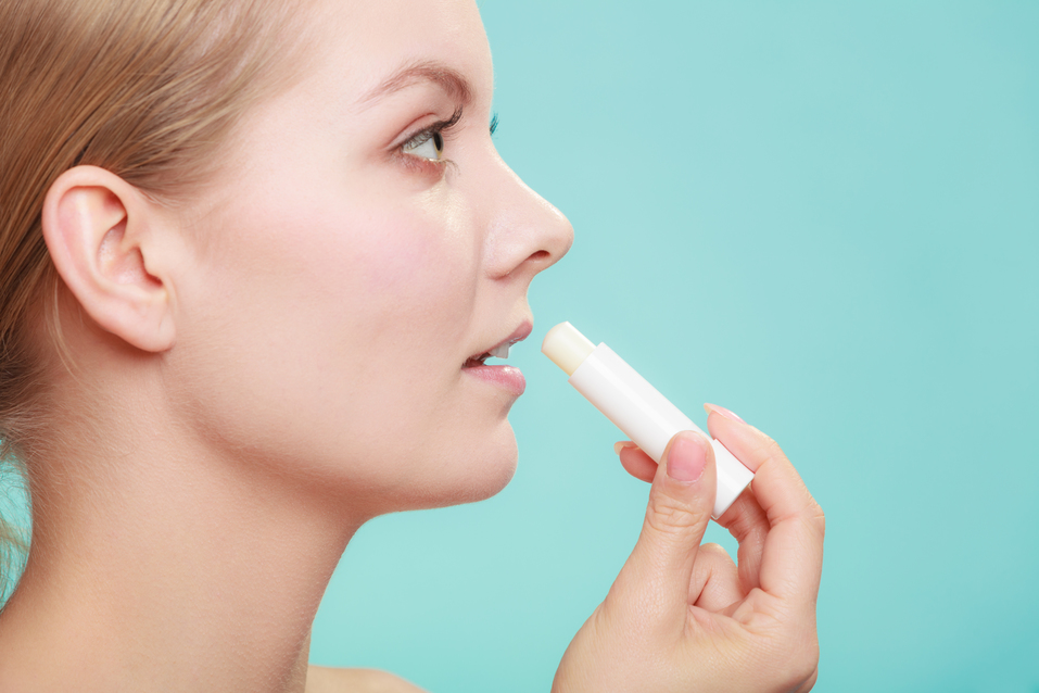 woman applying balsam for lips